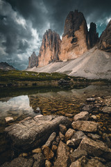 Three Peaks in the Dolomites reflecting in a lake, Italy