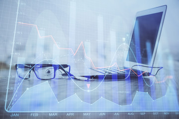 Stock market graph and table with computer background. Double exposure. Concept of financial analysis.