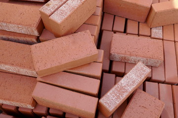 Red paving stones in the building materials trade for sale. Close-up