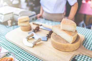 Close up of cheese on stand at food festival.