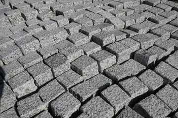 Granite stones for natural stone paving in the building materials trade for sale, close-up