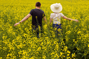 Beautiful couple in a yellow rapeseed field