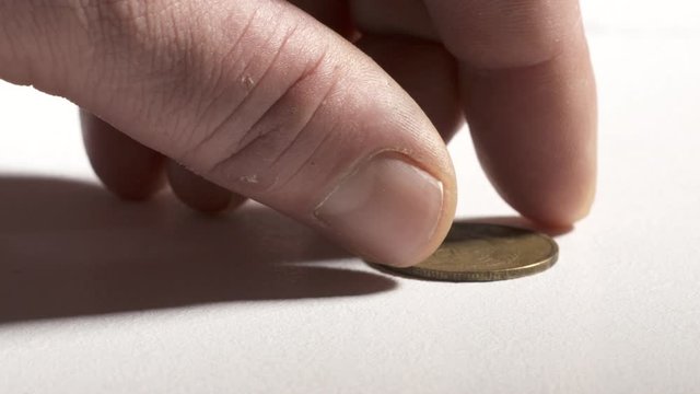 Hand taking 5 Kopeks USSR Russian Soviet coin from desk.