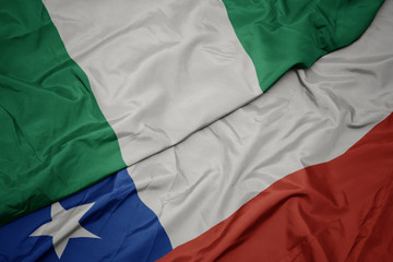 waving colorful flag of chile and national flag of nigeria.