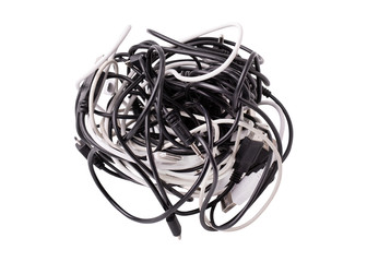A coil of various wires for gadgets on a white background. Black and white wires tangled together. Tangle of tangled wires usb and micro usb, audio cable jack.