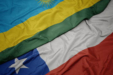 waving colorful flag of chile and national flag of rwanda.