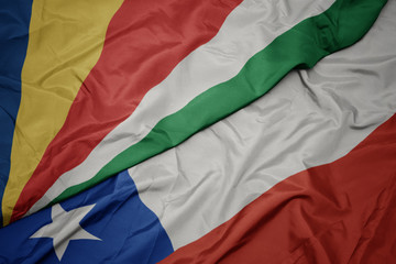 waving colorful flag of chile and national flag of seychelles.
