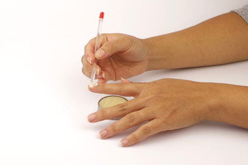Close-up of a female performing a manicure on herself