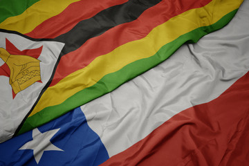 waving colorful flag of chile and national flag of zimbabwe.