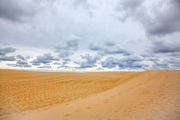 Fototapeta na wymiar low clouds over the sandy beach