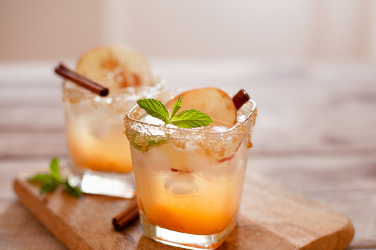 Apple cider cocktail with cinnamon and apple traditional autumn and winter drink