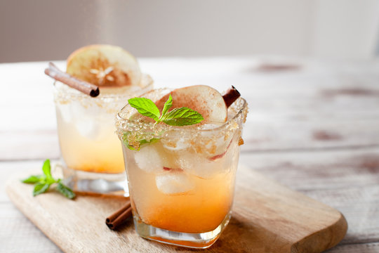 Apple cider cocktail with cinnamon and apple traditional autumn and winter drink