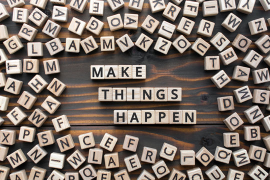 make things happen - phrase from wooden blocks with letters, keep it simple motivational concept, random letters around, white  background