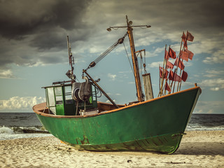 Fish cutter moored at the sandy beach