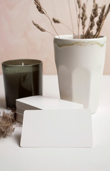White business card mockup with cup and candle.
