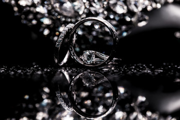 wedding rings with diamonds on black background