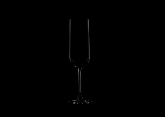 The outlines of transparent glass goblets on a black background