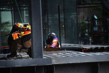 Construction worker welding steel