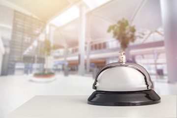 Vintage hotel reception service desk bell on blurred background