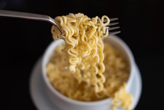 Instant Noodles And Fork On Dark Background. Cheap Food. 