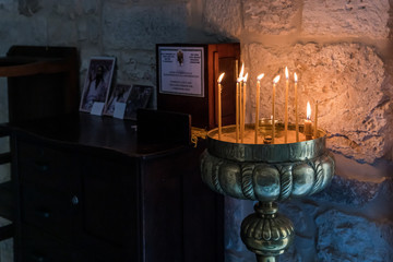 Place for lighting candles in the Church of St. John the Baptist in the Old City in Jerusalem, Israel