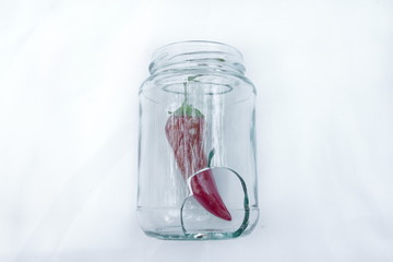 Broken jar with red hot chili pepper