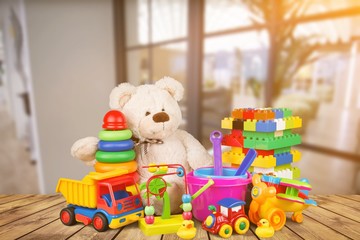 Toys collection isolated on wooden table on kids room