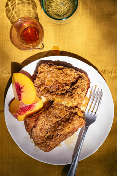 French Toast with Streusel and Peaches on Mustard Colored Background