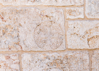 Cross carved in stone on the wall of the Church of St. John the Baptist in the Old City in Jerusalem, Israel