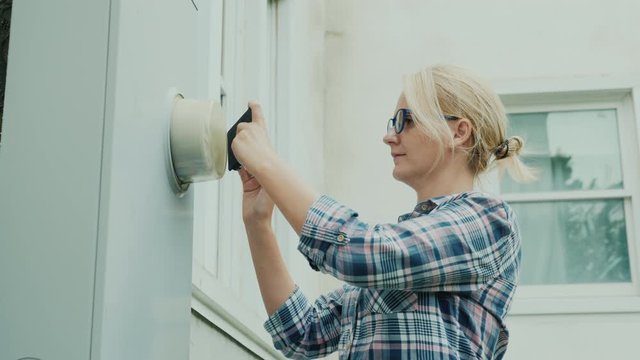 Woman takes pictures of electricity meter