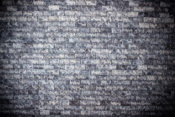 Grey brick wall texture. Old rough brickwork. Dark grunge background