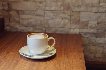 cup of coffee on wooden table