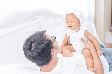 Lovely family, father holding and playing with his little girl. Happy family in the weekend. Father's day concept.