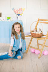 Cute girl with easter bunnies in the room decorative for the holiday. Easter mood