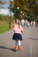 Fototapeta premium Little girl on a scooter