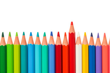 Color pencils arranged horizontally in a line on white background with one standing out from the rest, with space for text. It's symbol of leadership. teamwork. success and unique