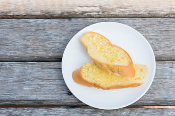 Delicious Garlic Bread on white plate, tasty dessert