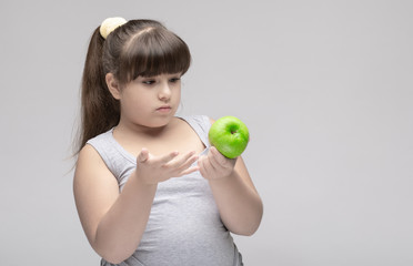 sad overweight girl with green Apple, don't want to diet .