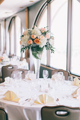 Fine wedding flower table arrangement at reception, pink, white and orange peonies, expensive wedding flowers