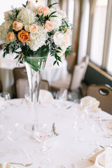 Fine wedding flower table arrangement at reception, pink, white and orange peonies, expensive wedding flowers