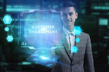 The concept of business, technology, the Internet and the network. A young entrepreneur working on a virtual screen of the future and sees the inscription: Customer engagement