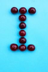 Capital Letter I fresh cherry alphabet blue color flat lay