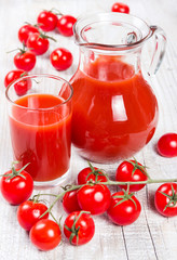 Tomato juice on a wooden background