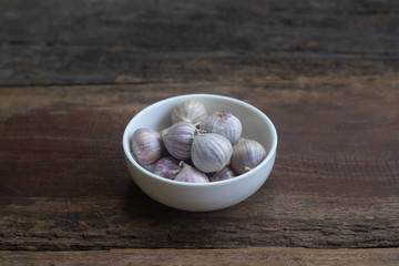 Top view of herbal vegetable ingredients, fresh garlic, on old wooden table, cooking preparation concept