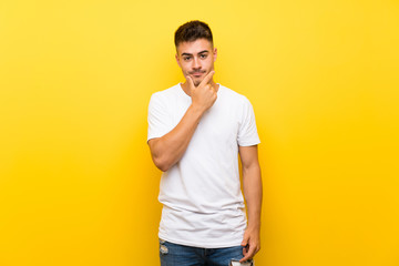 Young handsome man over isolated yellow background smiling