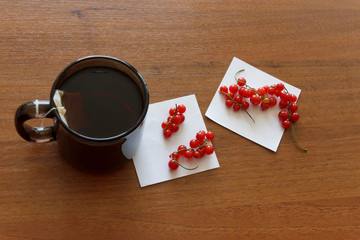 ripe currants on a piece of paper. morning tea in the office