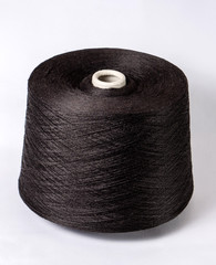 bobbin of yarn on a white background. Side view.Textile reel on isolated white background.