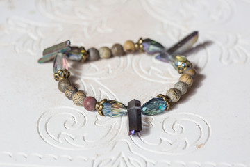 Mineral stone bracelet on natural neutral decorative background