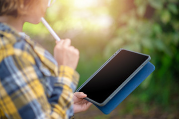 Close up of woman holding tablet and thinking. Lifestyle Concept