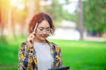 Close up of woman holding tablet and thinking. Lifestyle Concept